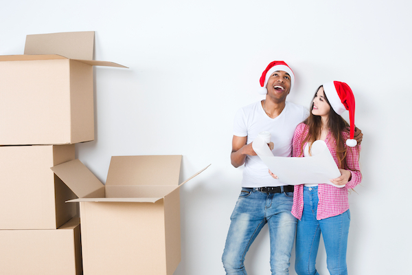 Moving,,Home,And,Couple,Concept,-,Smiling,Couple,In,Santa