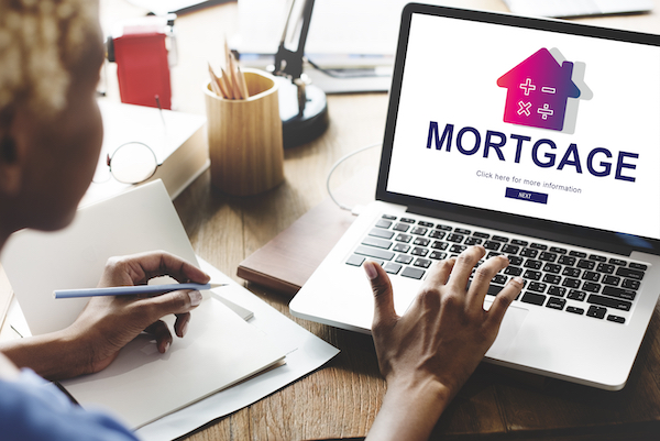 Woman Researching Mortgages On Laptop